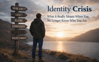 Person standing alone by a lake at sunset reflecting on identity crisis and life transition