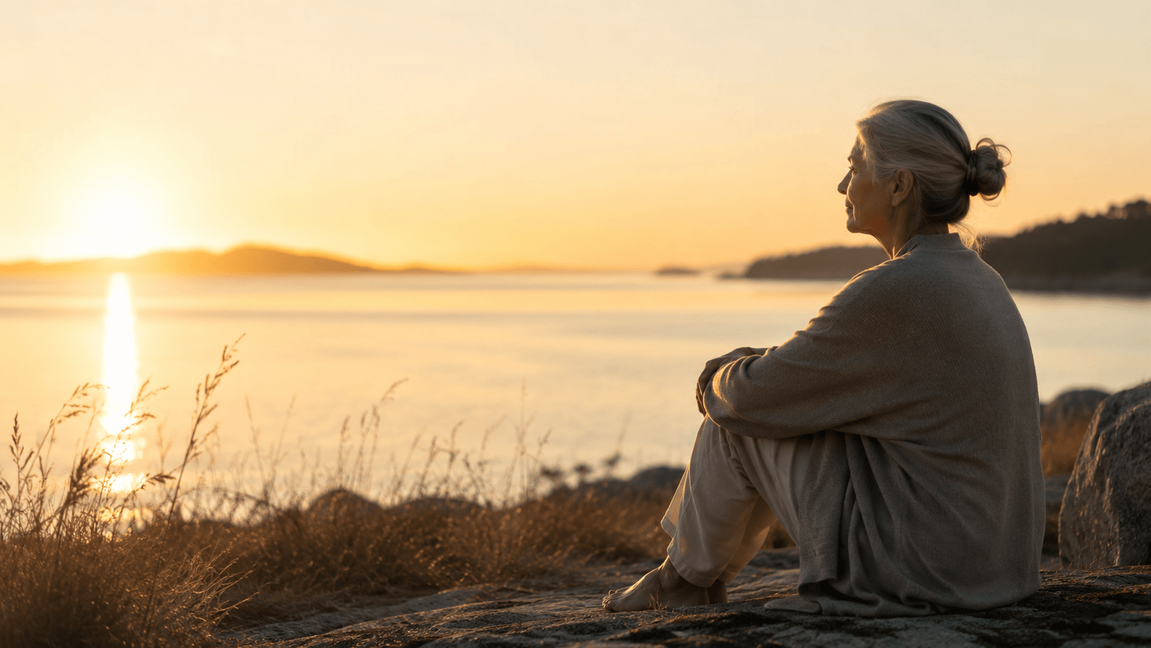 A mature person sitting quietly in soft morning light, symbolising silence, self-awareness and returning to the true self.